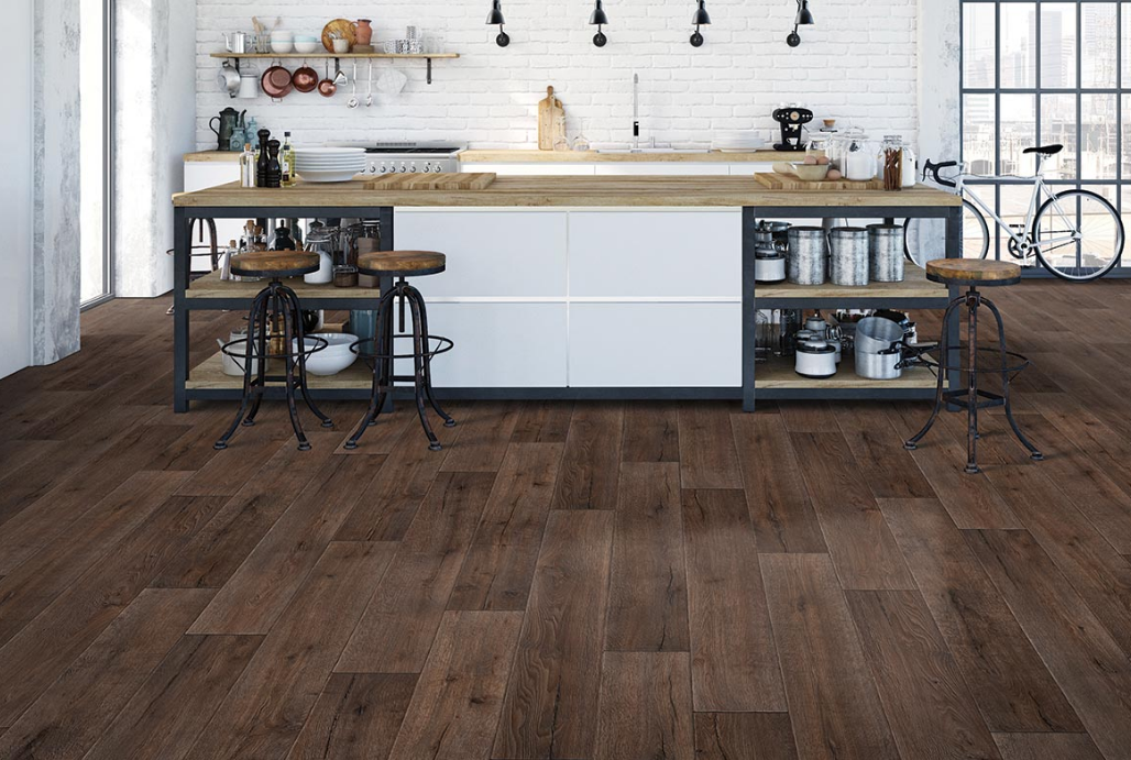 Dark brown Mohawk luxury vinyl plank flooring adds extreme style to a modern kitchen with a long island.
