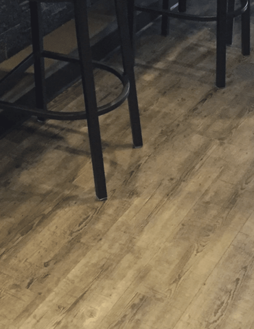 Laminate or luxury vinyl flooring in a basement in Glen Ellyn, IL from Superb Carpets, Inc.