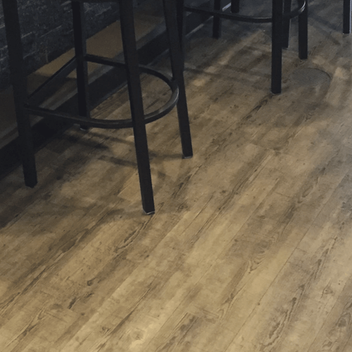 Laminate or luxury vinyl flooring in a basement in Glen Ellyn, IL from Superb Carpets, Inc.